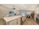 Spacious living area featuring an island with seating, a large sectional couch, and modern appliances at 6435 165Th E Dr, Parrish, FL 34219