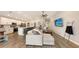 Spacious living area featuring an island with seating and a large sectional couch at 6435 165Th E Dr, Parrish, FL 34219