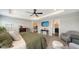 Bright main bedroom featuring a plush bed, stylish decor, and easy access to the adjoining bathroom and living areas at 6435 165Th E Dr, Parrish, FL 34219