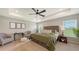 Spacious main bedroom featuring a tray ceiling, plush seating, and large windows offering ample natural light at 6435 165Th E Dr, Parrish, FL 34219