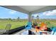 Screened patio featuring colorful chairs, offering a cozy outdoor space with scenic views at 6435 165Th E Dr, Parrish, FL 34219