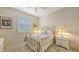 Cozy bedroom with plantation shutters, ceiling fan and carpeted floor at 7012 Treymore Ct, Sarasota, FL 34243
