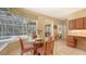 Cozy dining area adjacent to the pool, features a glass table and direct access to outdoor amenities at 7012 Treymore Ct, Sarasota, FL 34243