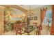 Inviting dining room featuring a glass table, tropical mural, and unique chandelier at 7012 Treymore Ct, Sarasota, FL 34243