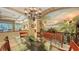Inviting dining room featuring a glass table, tropical mural, and unique chandelier at 7012 Treymore Ct, Sarasota, FL 34243