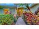 Charming front entrance featuring a brick pathway and colorful landscaping leading to the double-door entrance at 7012 Treymore Ct, Sarasota, FL 34243