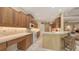 Spacious kitchen boasts wood cabinets, modern appliances, and seamless access to an inviting dining area at 7012 Treymore Ct, Sarasota, FL 34243