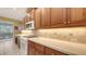 Well-equipped kitchen features stylish countertops, a gas range, and sleek microwave oven at 7012 Treymore Ct, Sarasota, FL 34243