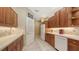 Functional kitchen with plentiful cabinets, white appliances, and a convenient breakfast bar at 7012 Treymore Ct, Sarasota, FL 34243