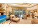 Cozy living room featuring neutral colors, tray ceiling, and a view of the outdoor patio at 7012 Treymore Ct, Sarasota, FL 34243