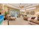 Inviting living room with plush seating, a ceiling fan, and screened outdoor area access at 7012 Treymore Ct, Sarasota, FL 34243