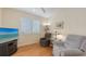 Cozy living room with wood floors, comfortable seating, and plenty of natural light streaming through the window at 7012 Treymore Ct, Sarasota, FL 34243