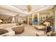 Spacious living room featuring elegant built-in shelving, stylish furnishings, and large windows at 7012 Treymore Ct, Sarasota, FL 34243