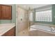 Bright bathroom with vanity, soaking tub and shower with glass door at 7012 Treymore Ct, Sarasota, FL 34243