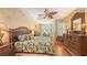 Serene main bedroom features a ceiling fan, ample natural light, and beautiful decorative touches at 7012 Treymore Ct, Sarasota, FL 34243