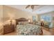Bright main bedroom with hardwood floors, ceiling fan and plantation shutters at 7012 Treymore Ct, Sarasota, FL 34243
