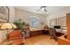 Well-lit home office featuring a large desk, custom wood built ins, and ample storage at 7012 Treymore Ct, Sarasota, FL 34243