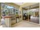 Screened patio with a stainless steel barbecue and mini fridge built into a brick counter at 7012 Treymore Ct, Sarasota, FL 34243