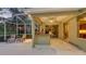 Covered patio with bar, fan and patio chairs at 7012 Treymore Ct, Sarasota, FL 34243