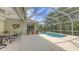Inviting swimming pool area with a screened enclosure, and nearby patio seating at 7012 Treymore Ct, Sarasota, FL 34243