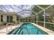 Backyard pool featuring clear water, screen enclosure and landscaped yard at 7012 Treymore Ct, Sarasota, FL 34243