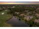 Luxury single-story home featuring a tile roof, swimming pool, water view, and golf course view at 7211 Pasadena Gln, Lakewood Ranch, FL 34202