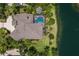 This stunning single-story home has a tile roof, screened in pool, and meticulously manicured lawn, next to water at 7211 Pasadena Gln, Lakewood Ranch, FL 34202