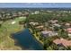 Aerial view of lakefront homes nestled amidst a golf course and lush landscaping at 7211 Pasadena Gln, Lakewood Ranch, FL 34202