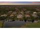 Elevated view of lakefront neighborhood homes surrounded by golf courses and manicured lawns at 7211 Pasadena Gln, Lakewood Ranch, FL 34202