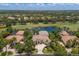 Luxury single-story home with a tile roof, lush landscaping, water view, and close proximity to golf course at 7211 Pasadena Gln, Lakewood Ranch, FL 34202