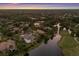 Aerial view of lakefront real estate in an upscale neighborhood at dusk at 7211 Pasadena Gln, Lakewood Ranch, FL 34202