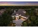 Aerial shot of a luxury home surrounded by manicured landscaping and a lush, wooded backdrop at 7211 Pasadena Gln, Lakewood Ranch, FL 34202