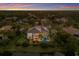 Waterfront single-story home featuring a tile roof, screened-in pool, and lush tropical landscaping in a private setting at 7211 Pasadena Gln, Lakewood Ranch, FL 34202