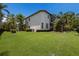 View of a large, well-maintained backyard with a screened lanai and a two-story home at 7211 Pasadena Gln, Lakewood Ranch, FL 34202