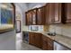 Wet bar features granite countertops, wood cabinetry, and a wine refrigerator at 7211 Pasadena Gln, Lakewood Ranch, FL 34202