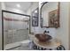 Unique bathroom with vessel sink, decorative mirror, and a tiled walk-in shower at 7211 Pasadena Gln, Lakewood Ranch, FL 34202