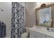 Bright bathroom with a shower and tub, vanity with sink, and decorative mirror at 7211 Pasadena Gln, Lakewood Ranch, FL 34202