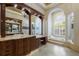 Elegant bathroom features a soaking tub, dual vanities, decorative columns, and a beautiful arched window at 7211 Pasadena Gln, Lakewood Ranch, FL 34202