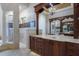 A luxurious bathroom with custom dark cabinets, a glass sink and a glass walk-in shower at 7211 Pasadena Gln, Lakewood Ranch, FL 34202