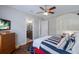 Inviting bedroom features hardwood floors, beach themed bedding and a ceiling fan at 7211 Pasadena Gln, Lakewood Ranch, FL 34202