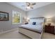 Charming bedroom features a cozy bed, carpet flooring, and a window with natural light at 7211 Pasadena Gln, Lakewood Ranch, FL 34202