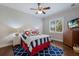 Cozy bedroom with nautical themed decor, ceiling fan, hardwood floors, and natural light at 7211 Pasadena Gln, Lakewood Ranch, FL 34202