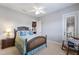 Comfortable bedroom with stylish furnishings, bright decor, and a view of the outdoors at 7211 Pasadena Gln, Lakewood Ranch, FL 34202