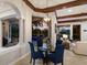 Elegant dining room with a round glass table offers a view of the pool and patio at 7211 Pasadena Gln, Lakewood Ranch, FL 34202