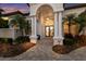 Home entryway features pillars, double doors with decorative glass, and professional landscaping at 7211 Pasadena Gln, Lakewood Ranch, FL 34202