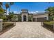 Stunning single-story home boasts an arched entryway, tile roof, a two-car garage, and meticulously manicured landscaping at 7211 Pasadena Gln, Lakewood Ranch, FL 34202