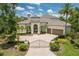 Stunning single-story home boasts an arched entryway, tile roof, a two-car garage, and meticulously manicured landscaping at 7211 Pasadena Gln, Lakewood Ranch, FL 34202