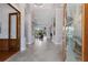 Inviting foyer with tile flooring, decorative glass doors, and an open view to the living room at 7211 Pasadena Gln, Lakewood Ranch, FL 34202