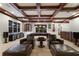 Expansive game room with a pool table, seating area, coffered ceilings and large windows for entertainment and relaxation at 7211 Pasadena Gln, Lakewood Ranch, FL 34202