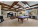 Spacious game room with coffered ceilings, a pool table, cozy seating, and a large window view, perfect for entertainment at 7211 Pasadena Gln, Lakewood Ranch, FL 34202
